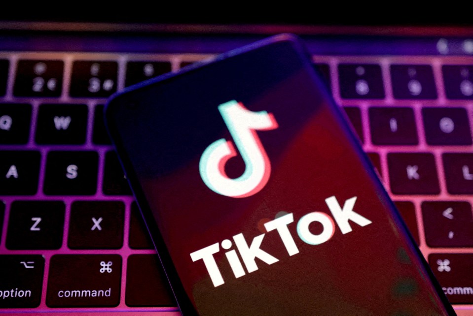 Illustration of the TikTok logo on a phone screen above a laptop keyboard.