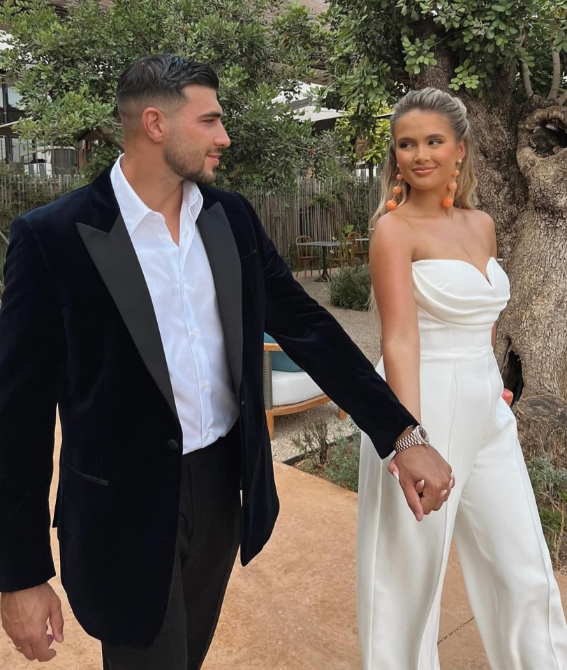 Tommy Fury and Molly-Mae Hague holding hands.