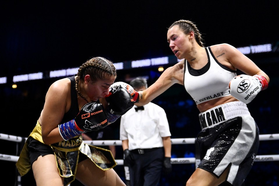 Demi Sims punches Nadeshi Hopkins in a boxing match.