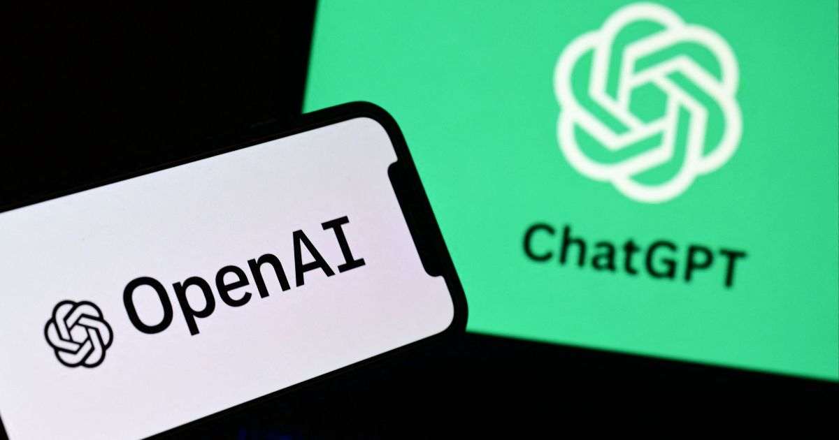 A photo taken on Oct. 4, 2023, in Manta, near Turin, Italy, shows a smartphone and a laptop displaying the logos of the artificial intelligence OpenAI research laboratory and ChatGPT.