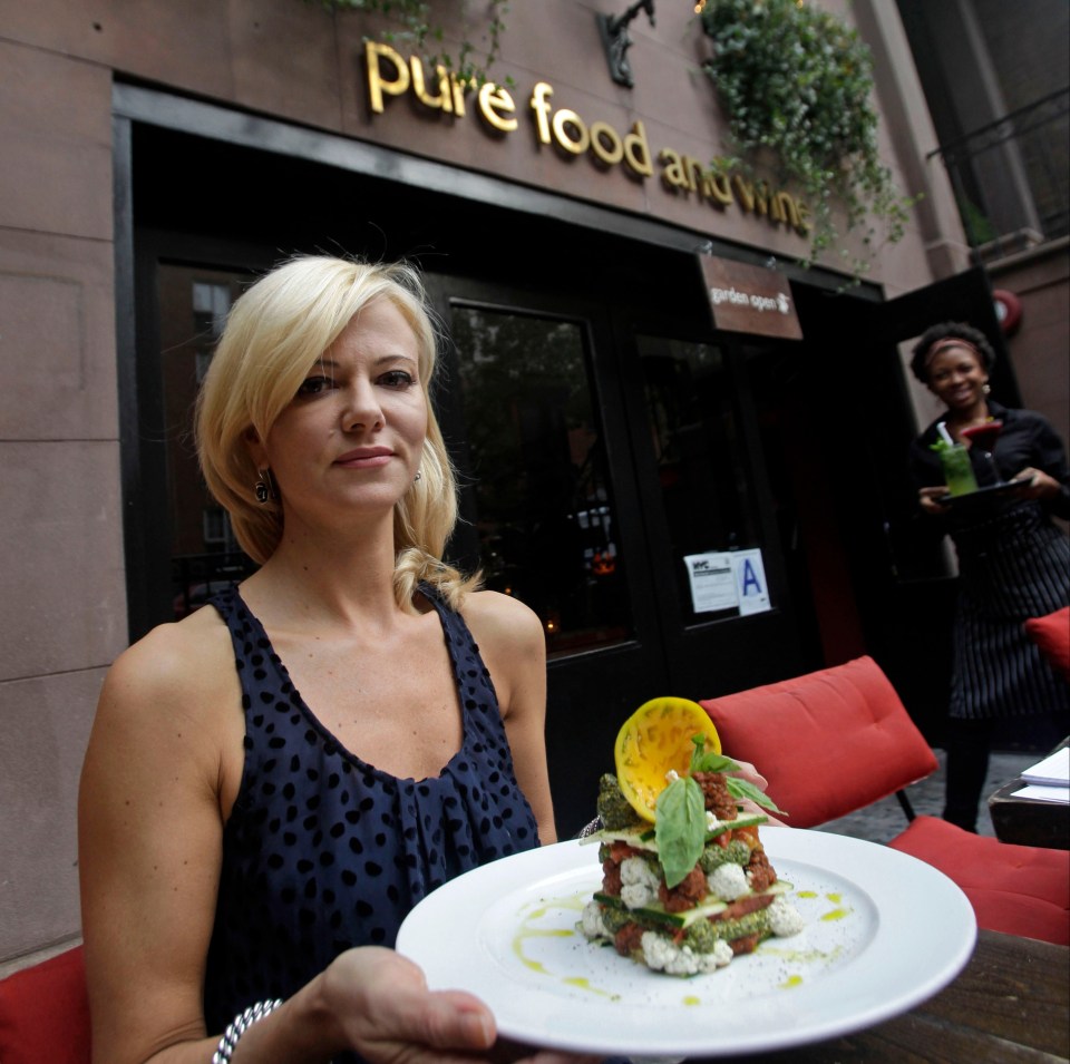 In this Tuesday, Oct. 18, 2011 photo, owner, founder and CEO Sarma Melngailis holds a plate featuring her restaurant's most popular dish, a local heirloom tomato lasagna featuring basil pistachio pesto, sun-dried tomato marinara, macadamia pumpkin seed ricotta and zucchini, in front of Pure Food and Wine in New York. The restaurant, which counts well-known celebrities, sports figures and politicians among it's clientele, serves only vegan and raw food. (AP Photo/Kathy Willens)
