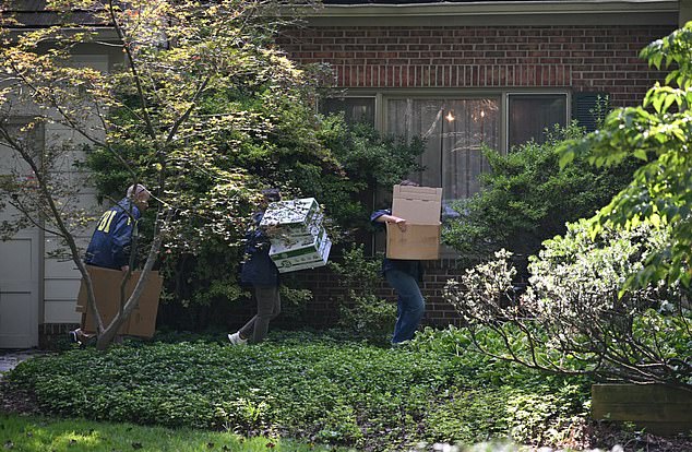 FBI agents carry boxes as they arrive at John Bolton's house, Donald Trump's former national security advisor after the FBI conducted a court-authorized search at his place on August 22, 2025 in Bethesda, Maryland. Federal Bureau of Investigation agents searched on Friday the home of John Bolton, Donald Trump's former national security advisor who has become a vocal critic of the US president. (Photo by SAUL LOEB / AFP) (Photo by SAUL LOEB/AFP via Getty Images)