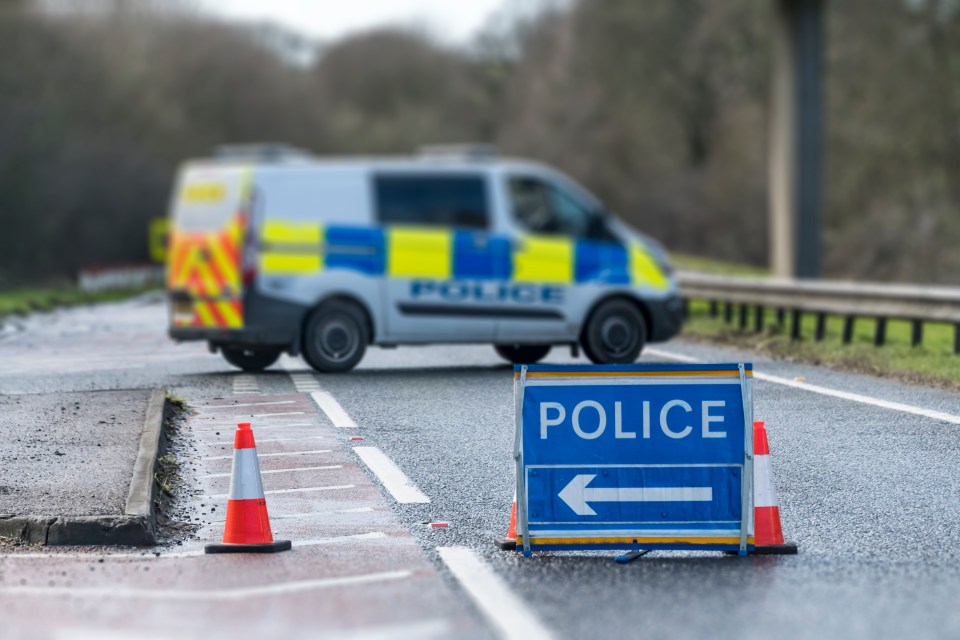 Police road closure sign and van.