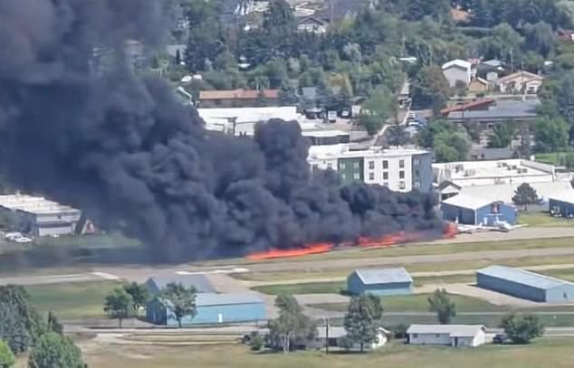 Flames and smoke can be seen at Kalispell Airport Monday after a plane crashed into a runway
