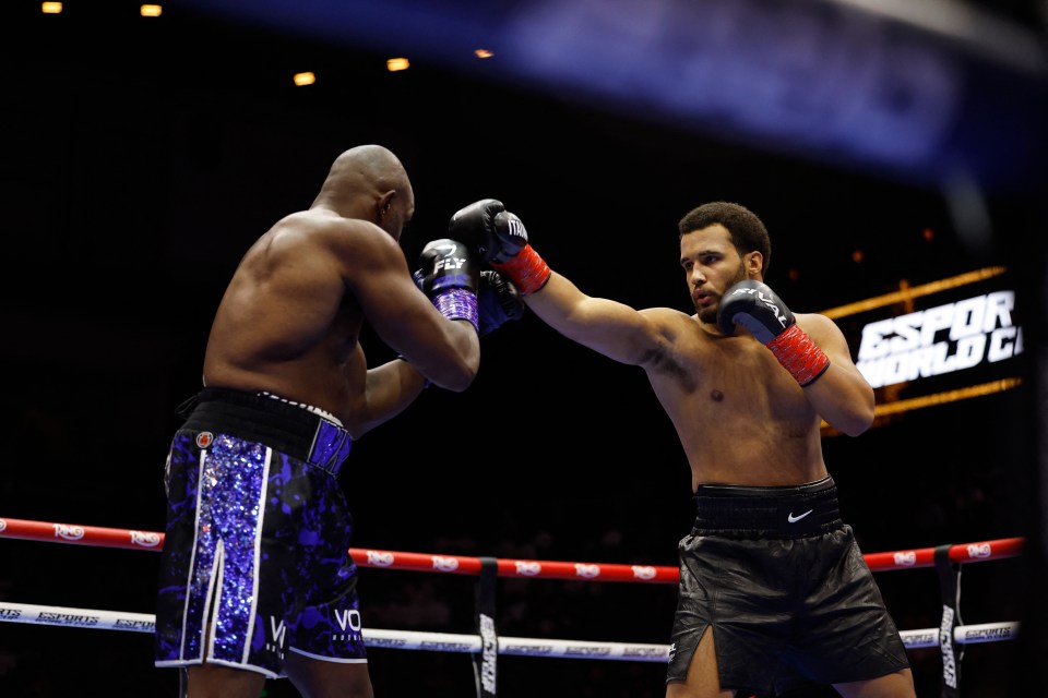 Moses Itauma punches Dillian Whyte during a boxing match.