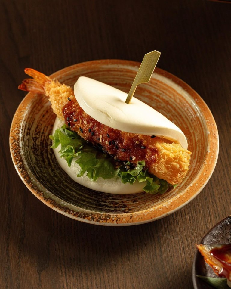 Fried shrimp bao on a small plate.