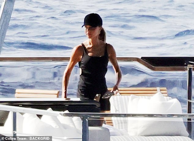 Victoria Beckham proudly looked on as son Romeo displayed his football skills on their yacht trip around Italy on Thursday