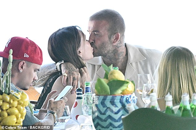 Victoria Beckham and her husband David couldn't keep their hands off each other during a recent family lunch with their children in Nerano, Italy , last week
