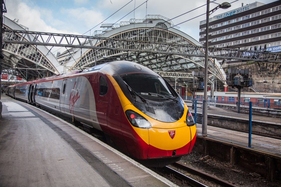 Virgin Pendolino train at a railway station.