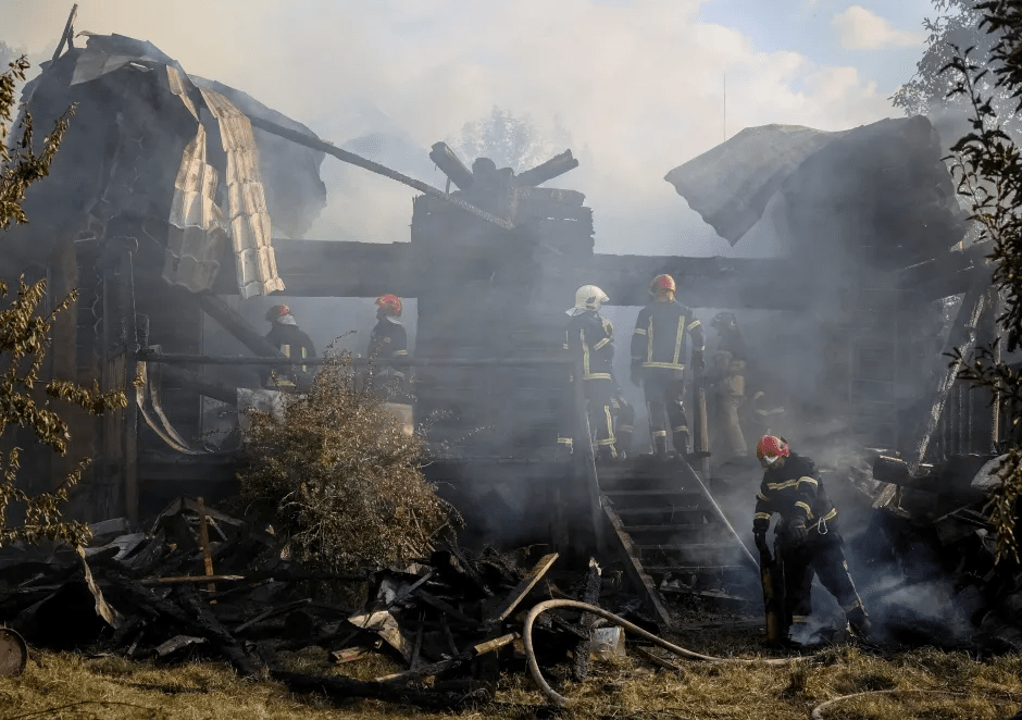 Firefighters at the scene of a burning building.