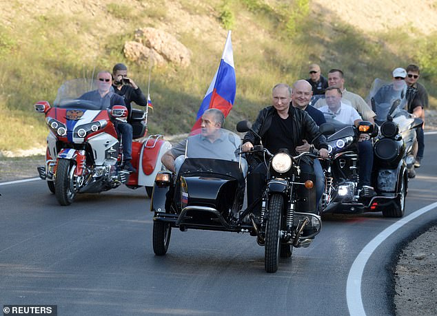 Vladimir Putin drives a Ural motorcycle at an event organized by motorcycling club 'Night Wolves' in Sevastopol, Crimea August 10, 2019