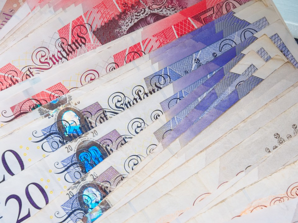 Close-up of a fanned stack of British twenty-pound notes.
