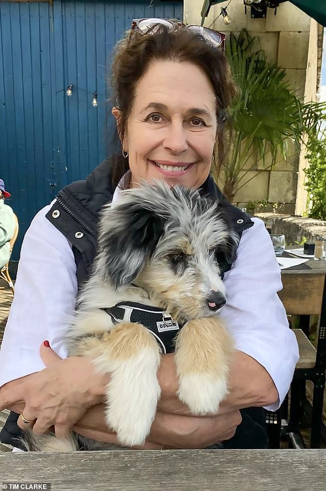 Two days before her murder, on her 65th birthday, Karen Carter (pictured) posed for what is believed to be her last ever photograph while out for lunch with friends. Smiling at the camera and cuddling her new puppy, Haku, the mother-of-four was on the brink of a new life