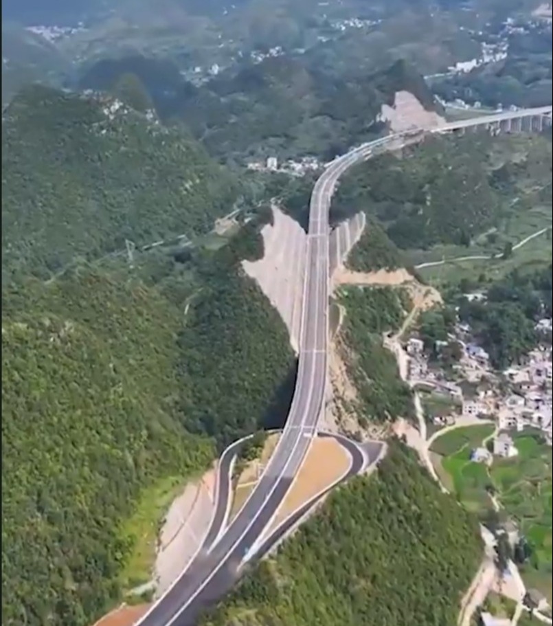 Aerial view of a highway cut through a mountain in China.