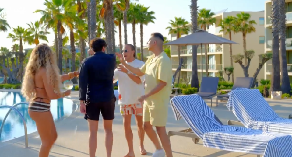 Screenshot of people by a pool.