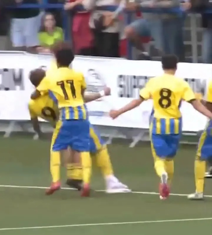 Soccer players celebrating a goal.