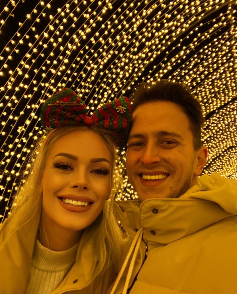 Aily and Nathan Chalmers smiling for a selfie in a tunnel of lights.