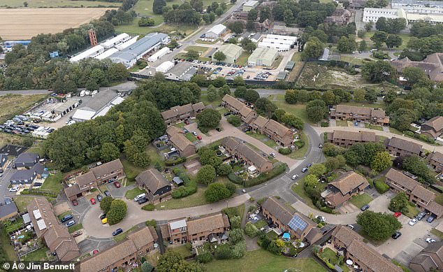 The small town, with just 1,975 people living in it, say the centre has sent house prices plummeting. It processes migrants who arrive from France across the Channel and they stay there for between 24 hours and a few days. Pictured: Manston centre and surrounding homes