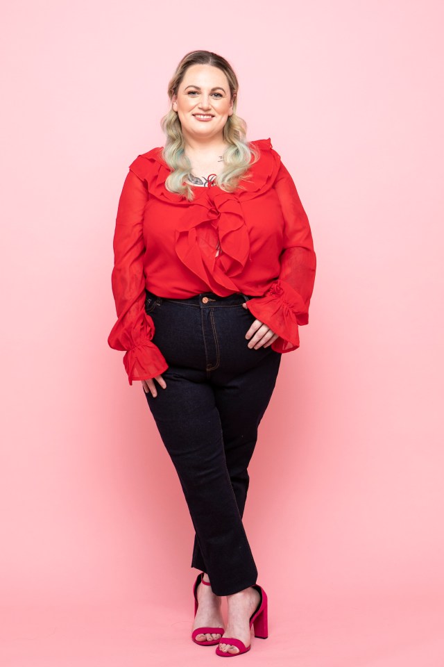 Portrait of a woman in a red blouse and dark jeans.