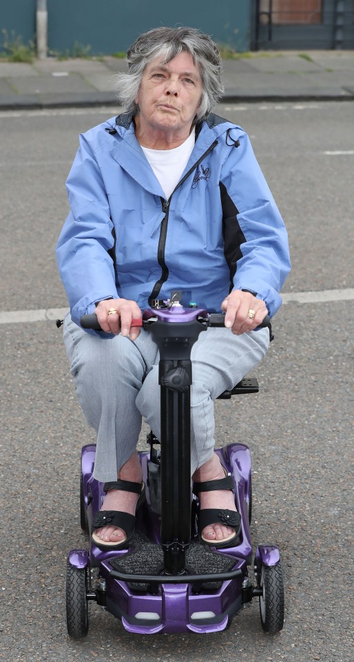 Woman with walker smiling for photo.