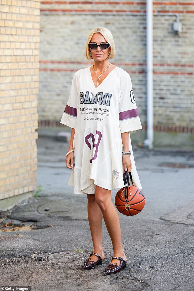 A guest outside at Copenhagen Fashion Week wearing a Ganni t-shirt dress