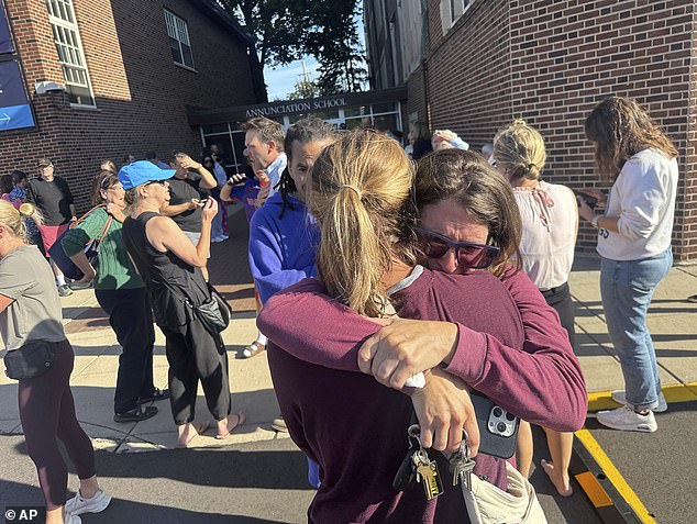 Parents await news of their children after a reported mass shooting at Annunciation Catholic School church