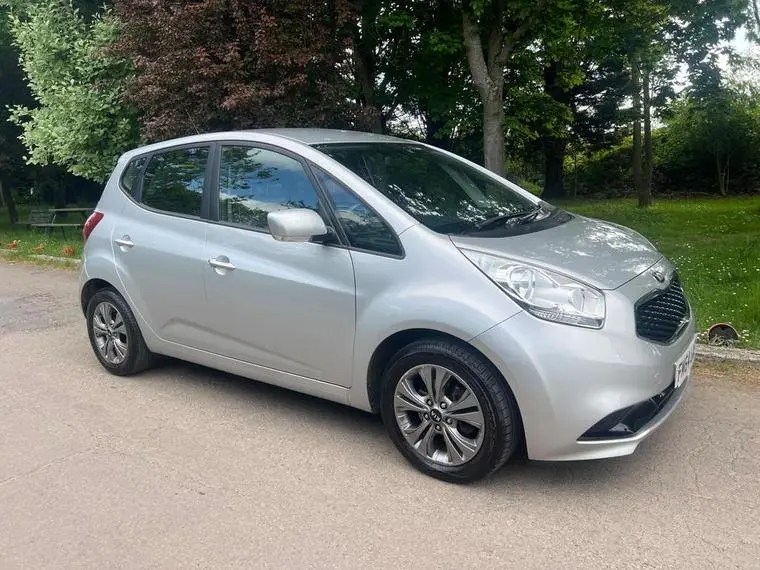 Silver Kia Venga parked outdoors.