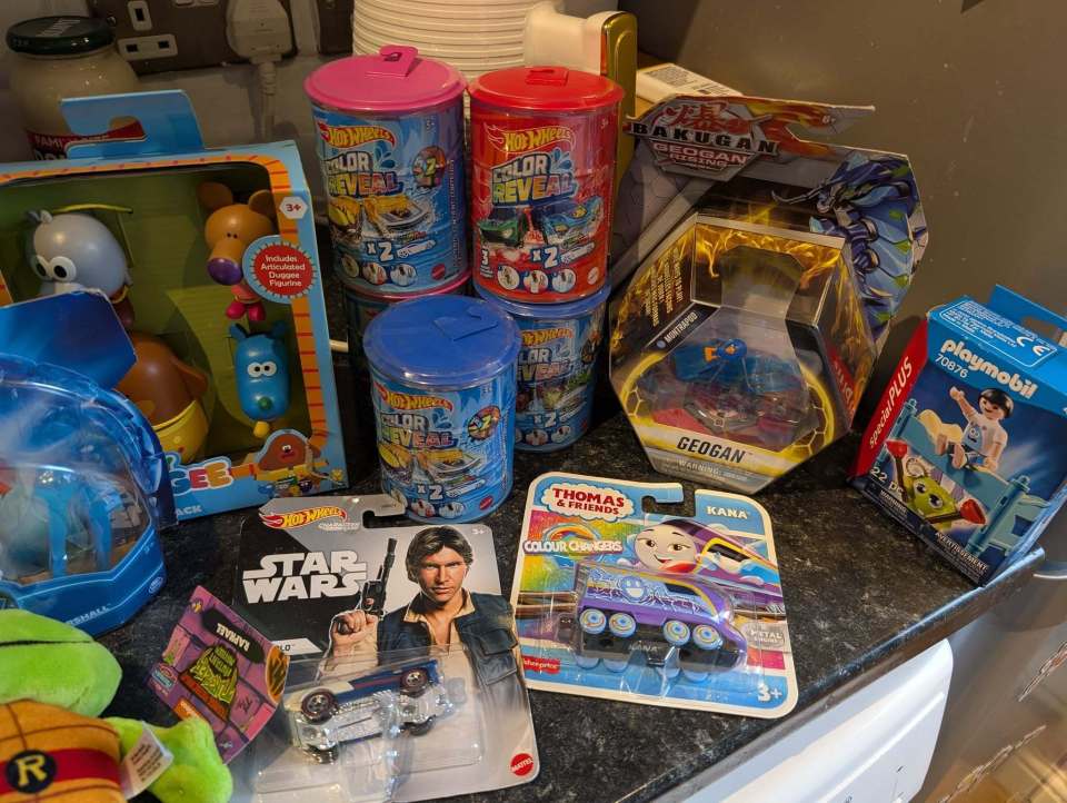 A collection of children's toys, including Hot Wheels, Star Wars, Thomas the Tank Engine, and Playmobil.