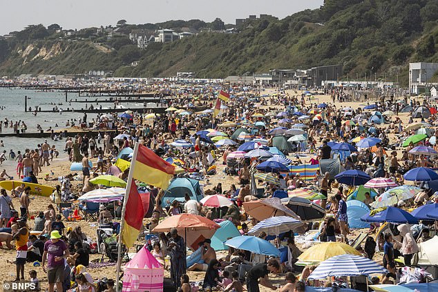 Thousands of people pack the beach at Bournemouth yesterday as sunseekers enjoy the heat