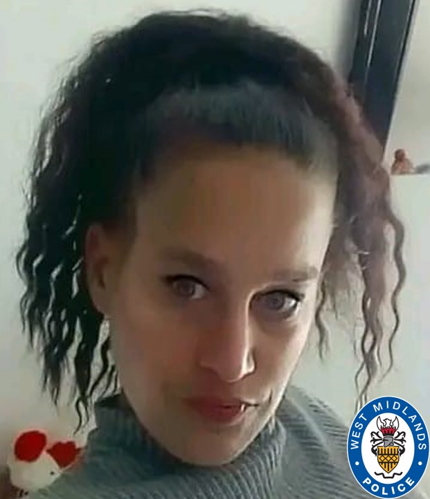 Photo of a woman with dark curly hair pulled back in a ponytail.