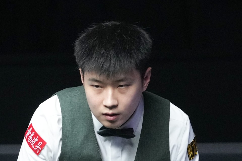 Zhao Xintong of China competing in a snooker match.