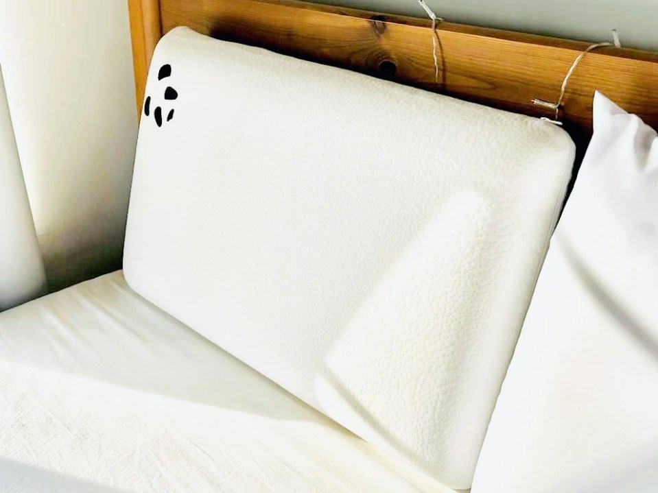 Panda memory foam bamboo pillow on a bed.