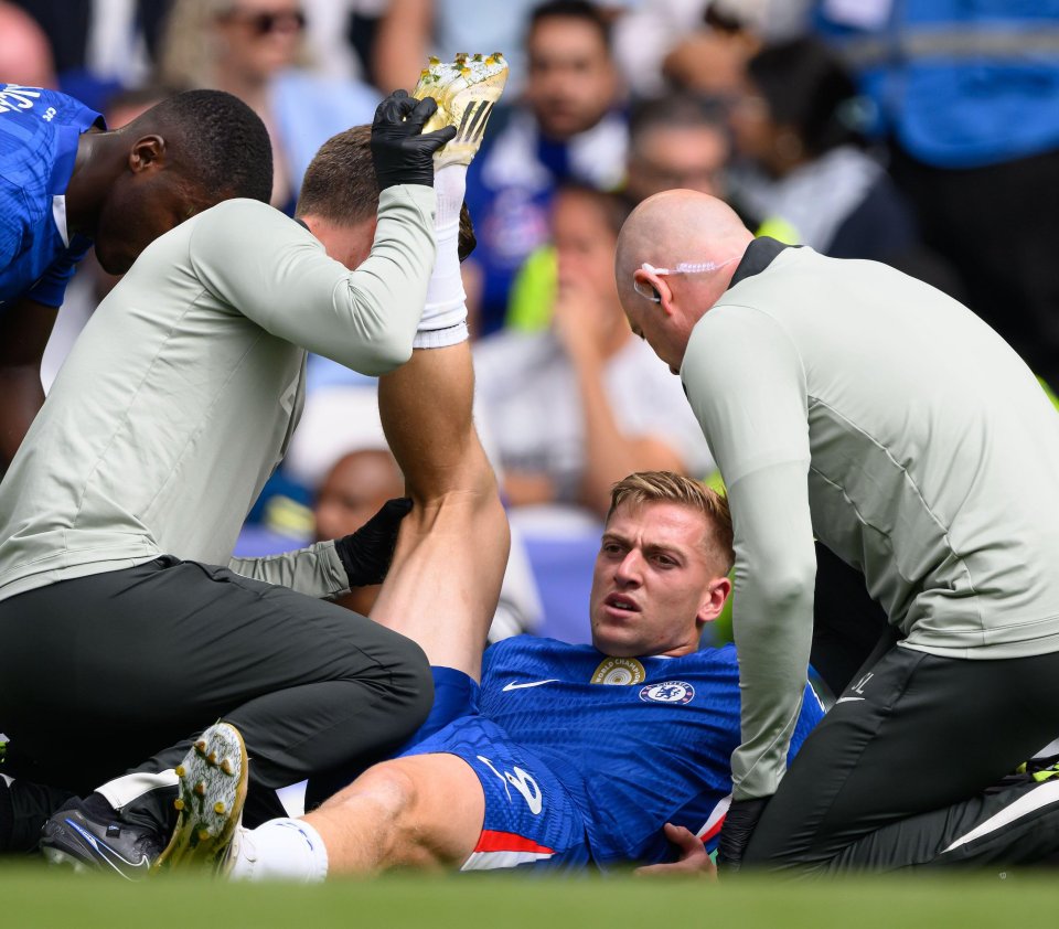 Chelsea's Liam Delap receiving medical attention on the field.