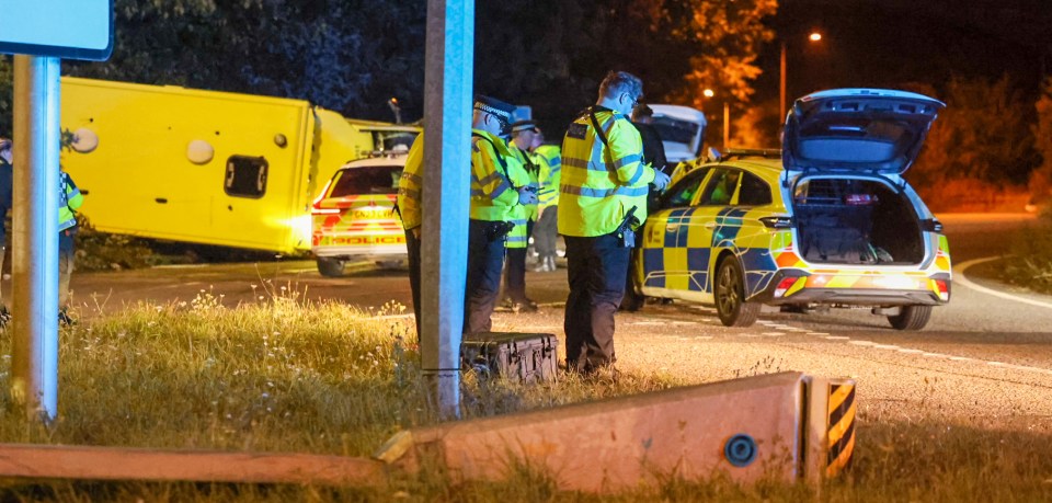 Emergency responders at the scene of an accident involving an overturned ambulance.