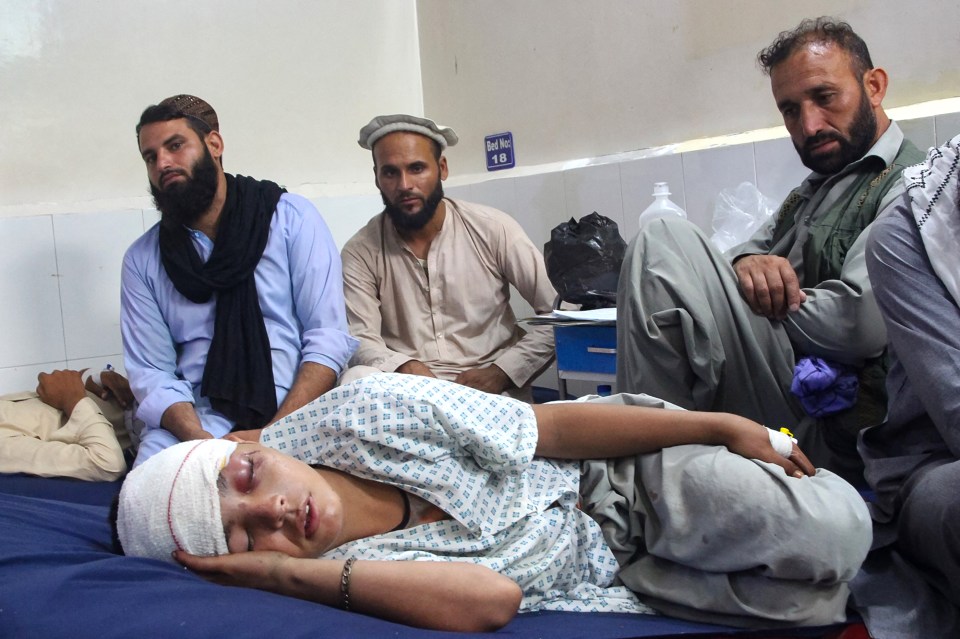 Injured boy receiving treatment in a hospital after an earthquake.