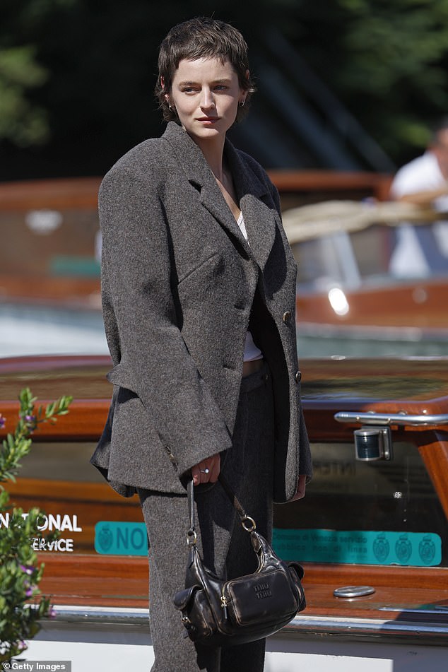 They looked effortlessly chic in a grey oversized tweed suit and carried a black leather Miu Miu handbag