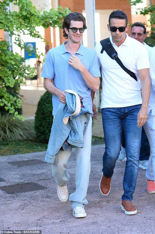 Andrew Garfield was beaming as he arrived in the city, wearing a casual light blue ensemble in the sun