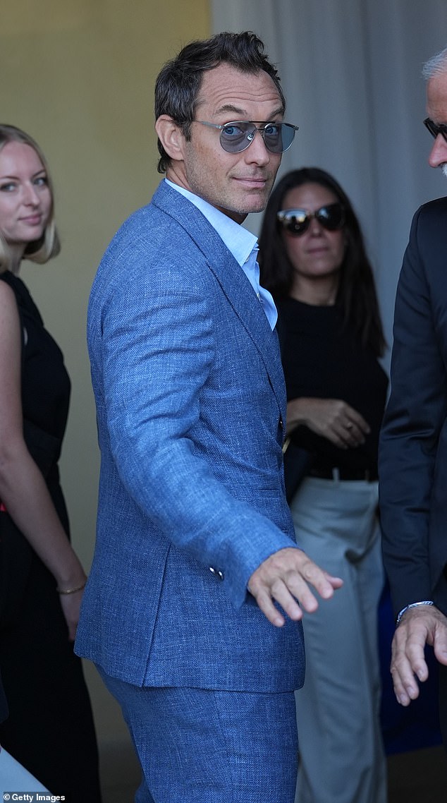 The BAFTA-winning star, 52, looked dapper in a blue tweed suit with tan suede loafers and a white Oxford shirt