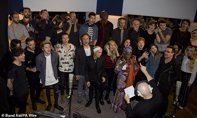 In 2014, Sugg (pictured in blue next to Ed Sheeran) appeared on the re-recording of Band Aid's Do They Know It's Christmas