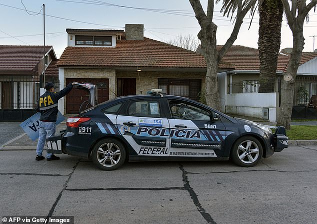 A member of the Argentine Federal Police (PFA) stands outside the house that was raided after a photo showing a 17th century masterwork allegedly stolen by the Nazis from a Dutch Jewish art collector appeared in an advertisement for the sale of the property, in Parque Luro neighbourhood, Mar del Plata