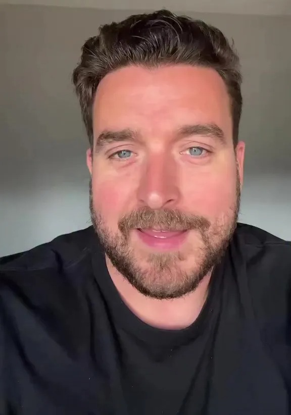 Man in black shirt introducing Teacher Summer Break Bingo.