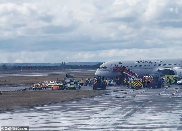 Emergency services gathered on the taxiway at Heathrow Airport after a Saudia Airlines jet's arrival was allegedly disrupted by a passenger