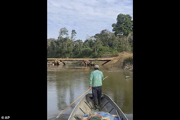 The boat built by the firm is inspected by a member of an indigenous group