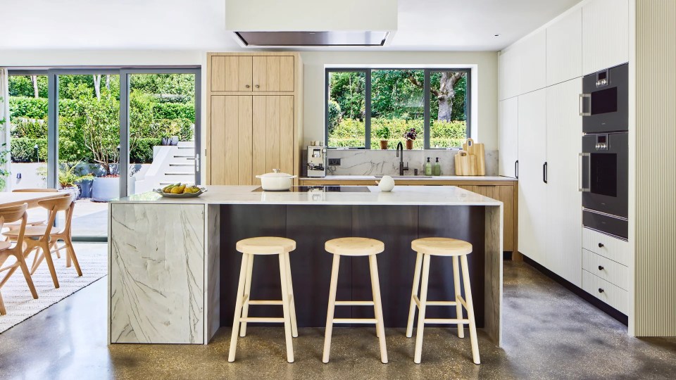 Modern kitchen with island and garden view.