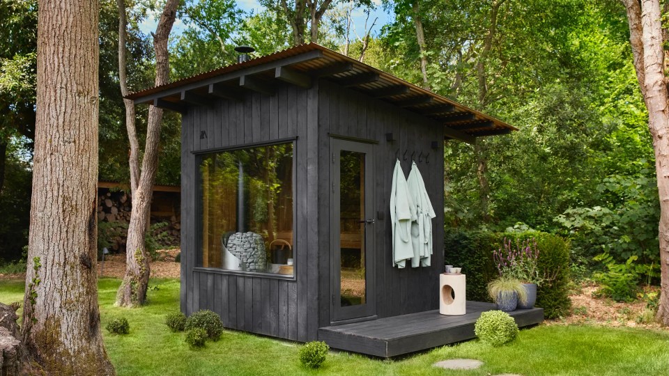 Outdoor sauna in a wooded area.