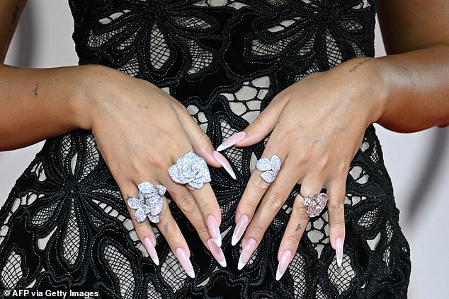 The influencer posed up a storm in a custom-made number by Roberto Cavalli as she held up her hands, showing off her giant 30-carat diamond ring and three other dazzling rings