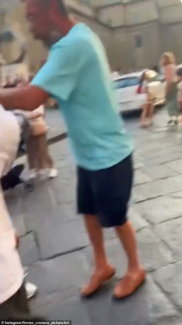 The thief is prevented from running away while another person repeatedly shouts for the police