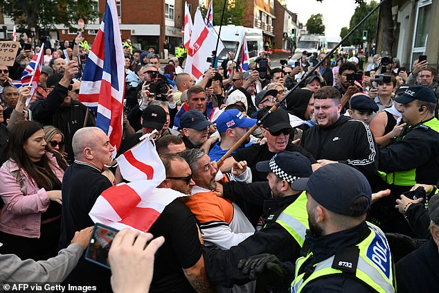 Anti-migrant protesters scuffle with police near the Bell Hotel in Epping yesterday