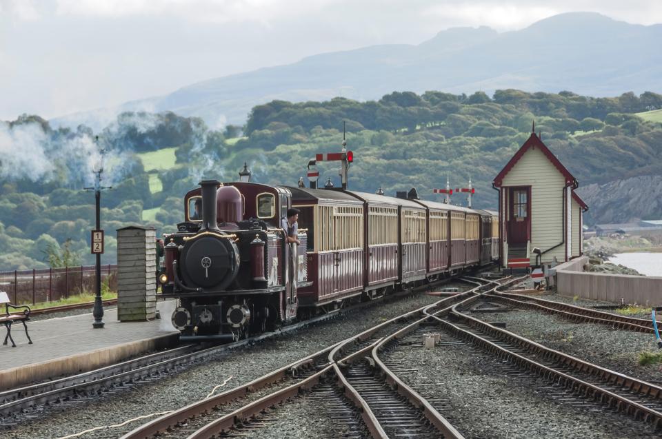 Narrow-gauge train arriving at a railway station.