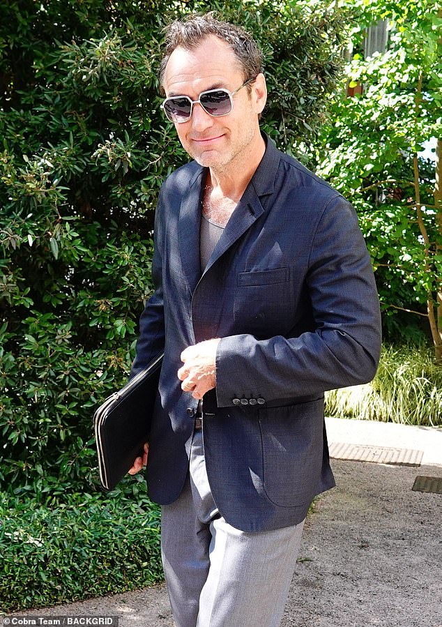 The British acting legend looked in very jovial spirits flashing a gentle beam as he sported a navy jacket, grey trousers and dark shades